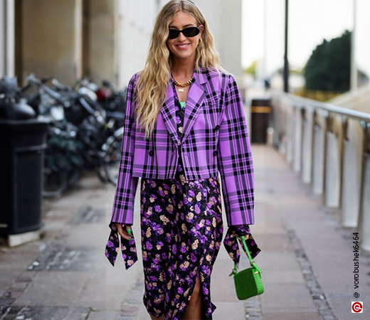 Model wearing a purple dress and jacket