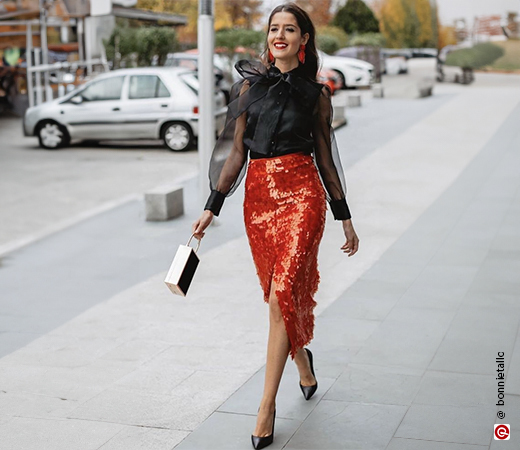 Model wearing red sequin skirt & black blouse