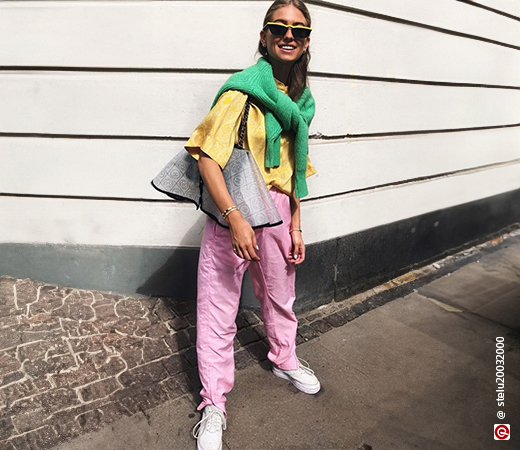 Model wearing pink pants and yellow shirt