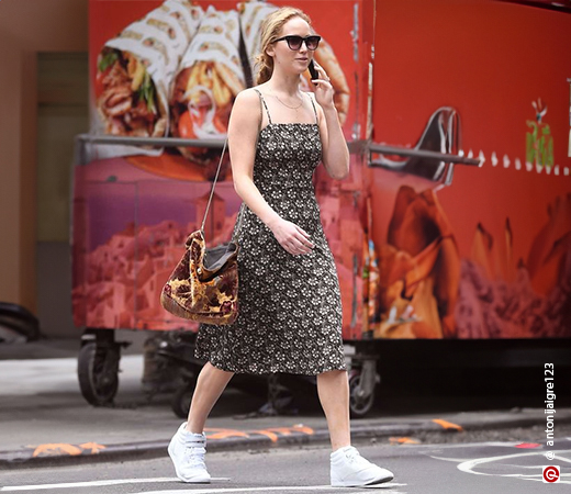 Jennifer Lawrence wearing a black midi dress with sneakers