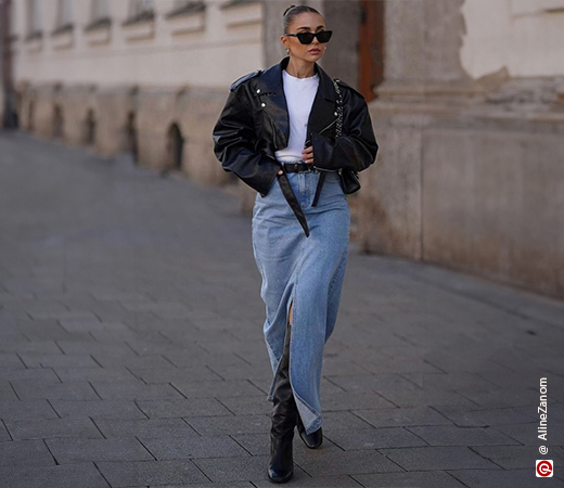 Woman wearing a long denim skirt with a leather jacket
