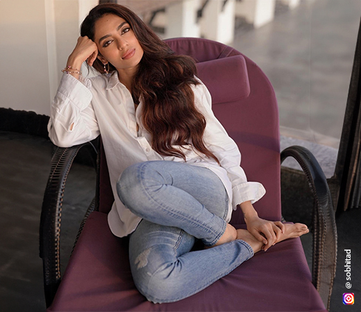 Sobhita Dhulipala wearing a white shirt and skinny jeans
