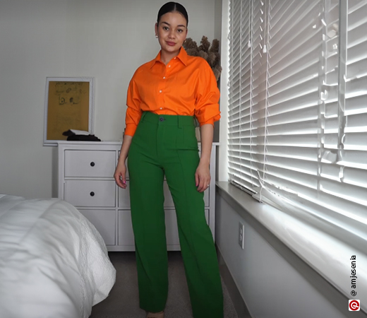 Woman wearing an orange shirt with green pants