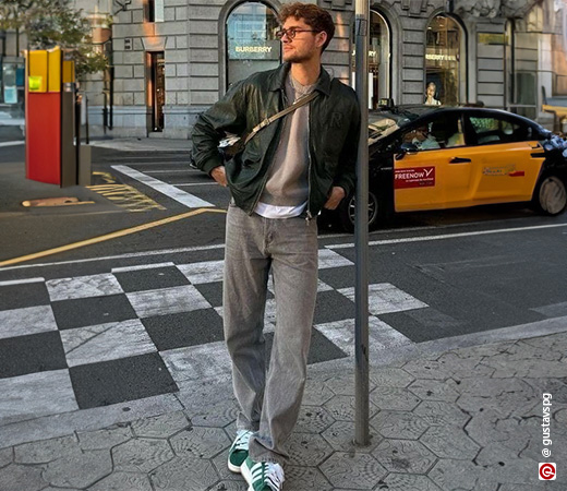 guy standing with the support of a pole
