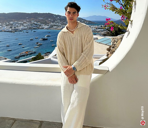  guy wearing a beige shirt with sea in the background
